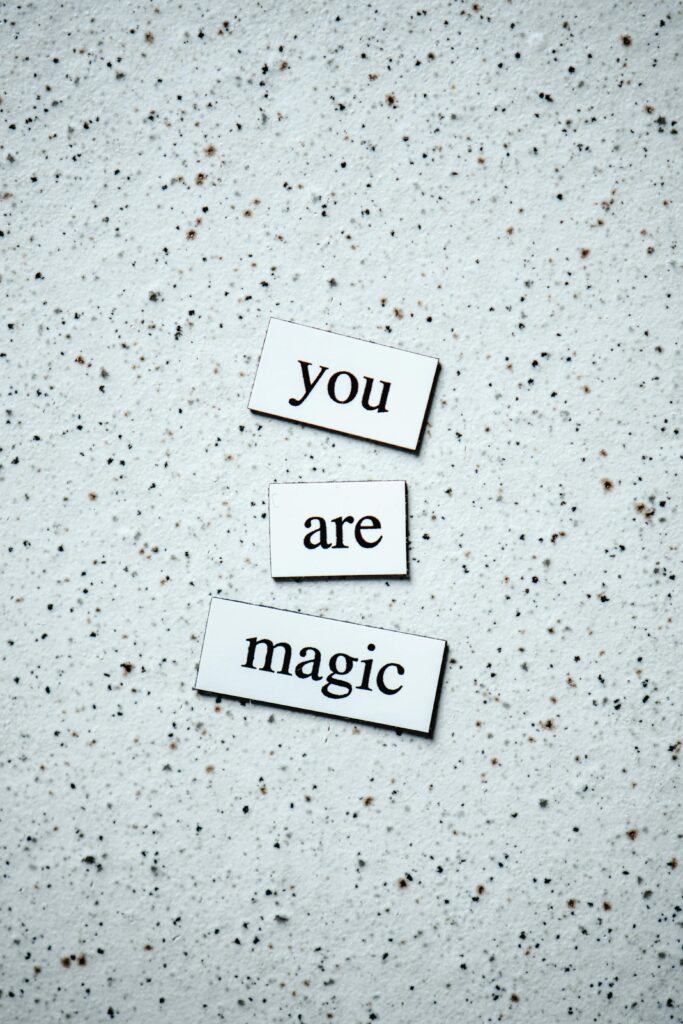 Artistic display of 'You are magic' text on a speckled surface. Motivational and uplifting design.