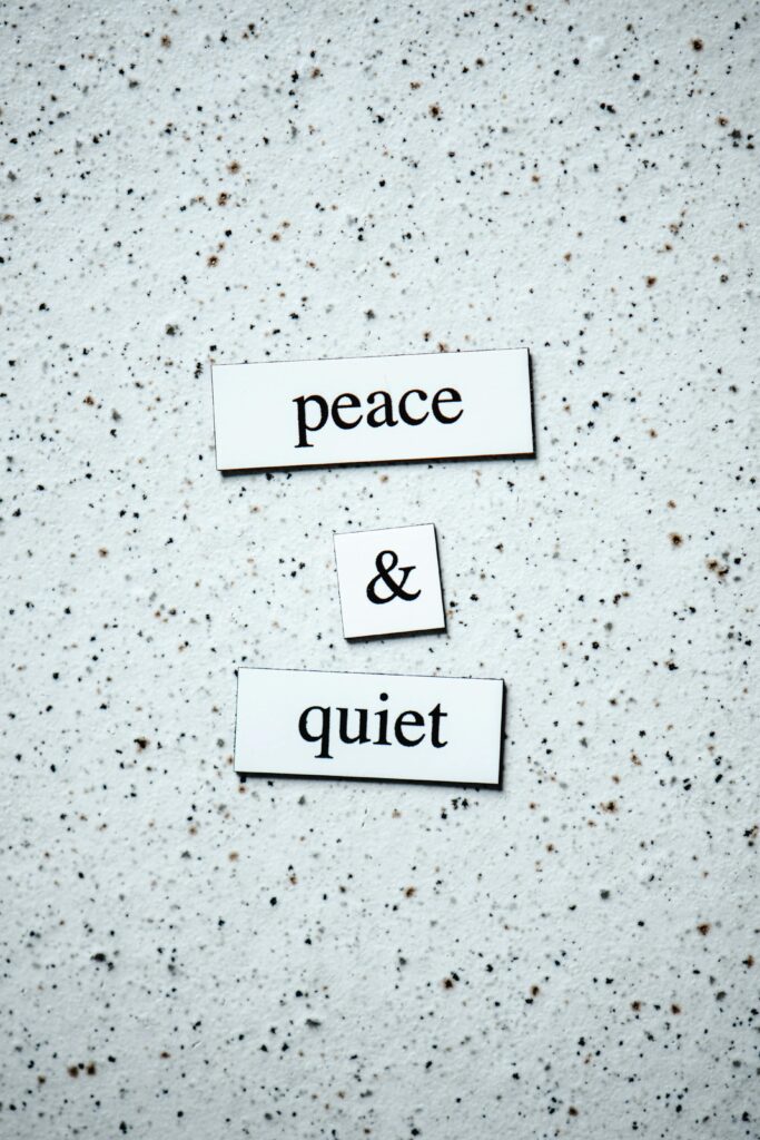 Inspirational text 'peace & quiet' on a minimalist textured background, perfect for serene quotes.
